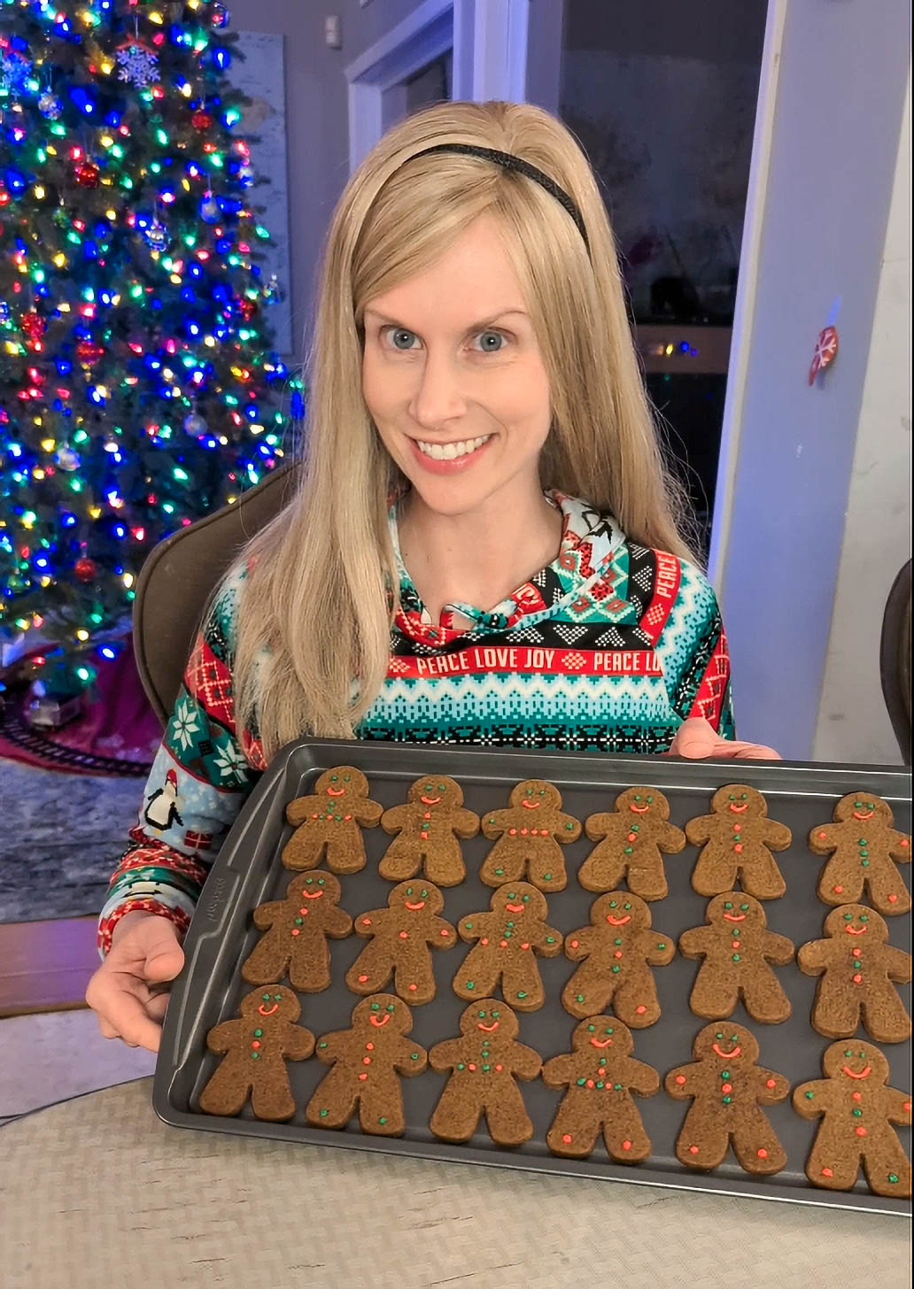 Dr. Novis holding a tray of decorated gingerbread cookies